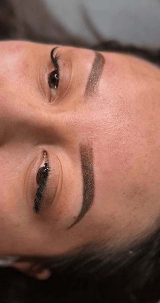 Brows immediately after the first ombre powder session, pigment still fresh and darker than the healed result